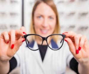 Byrnes Optometrist suggesting glasses from display at Optic shop